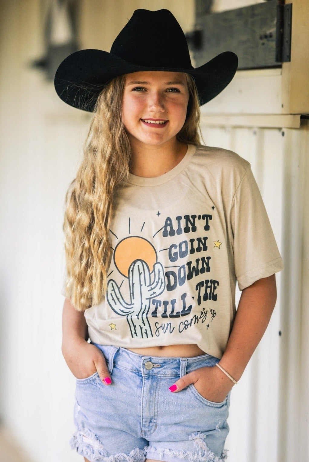 Handmade Bella + Canvas graphic tee with the text "Ain't Going Down Until the Sun Comes Up," perfect for country style and southern charm.