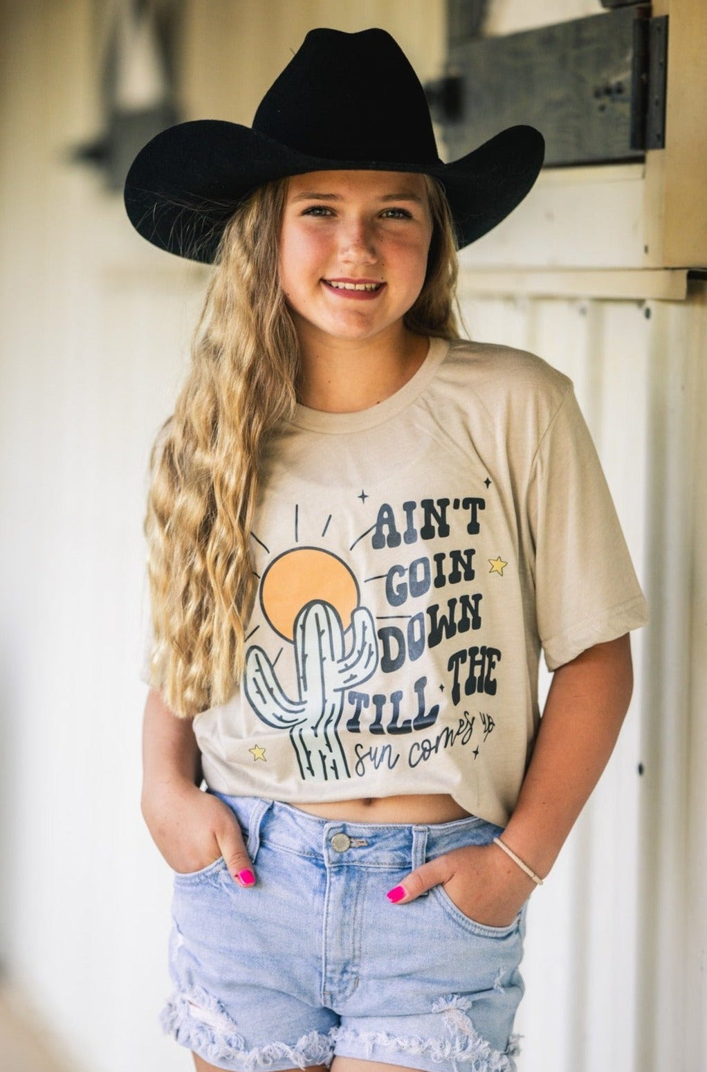 Handmade Bella + Canvas graphic tee with the text "Ain't Going Down Until the Sun Comes Up," perfect for country style and southern charm.