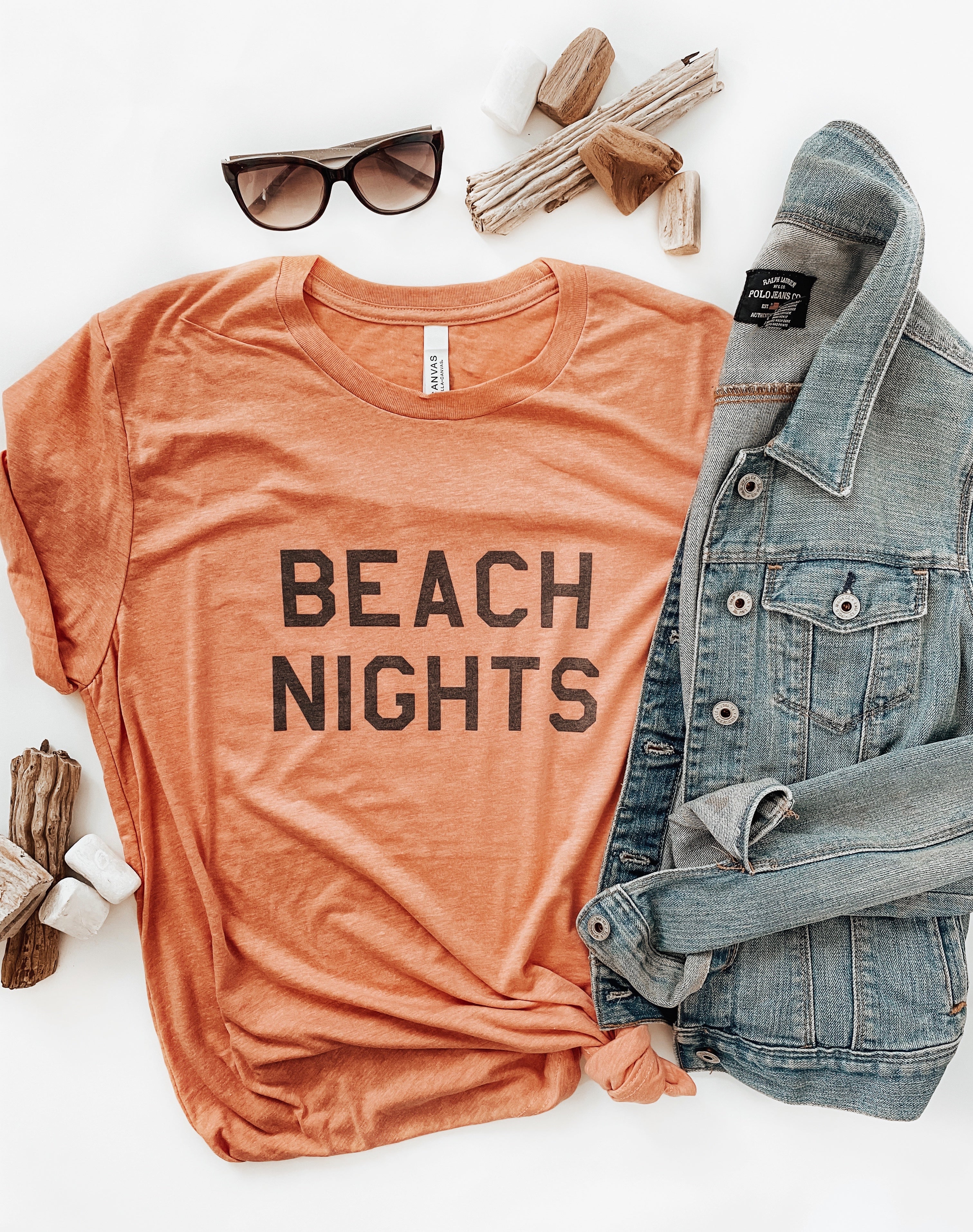 Heather Sunset Bella and Canvas T-shirt with the text "Beach Nights," featuring a design that captures the essence of relaxing and enjoying evenings at the beach.