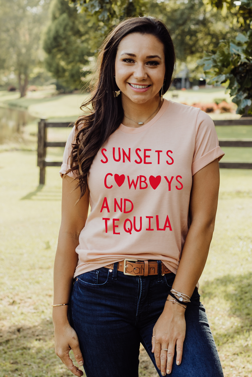 Super soft Bella and Canvas Peach colored vintage country girl tshirt with Sunsets, Cowboys and Tequila on it.
