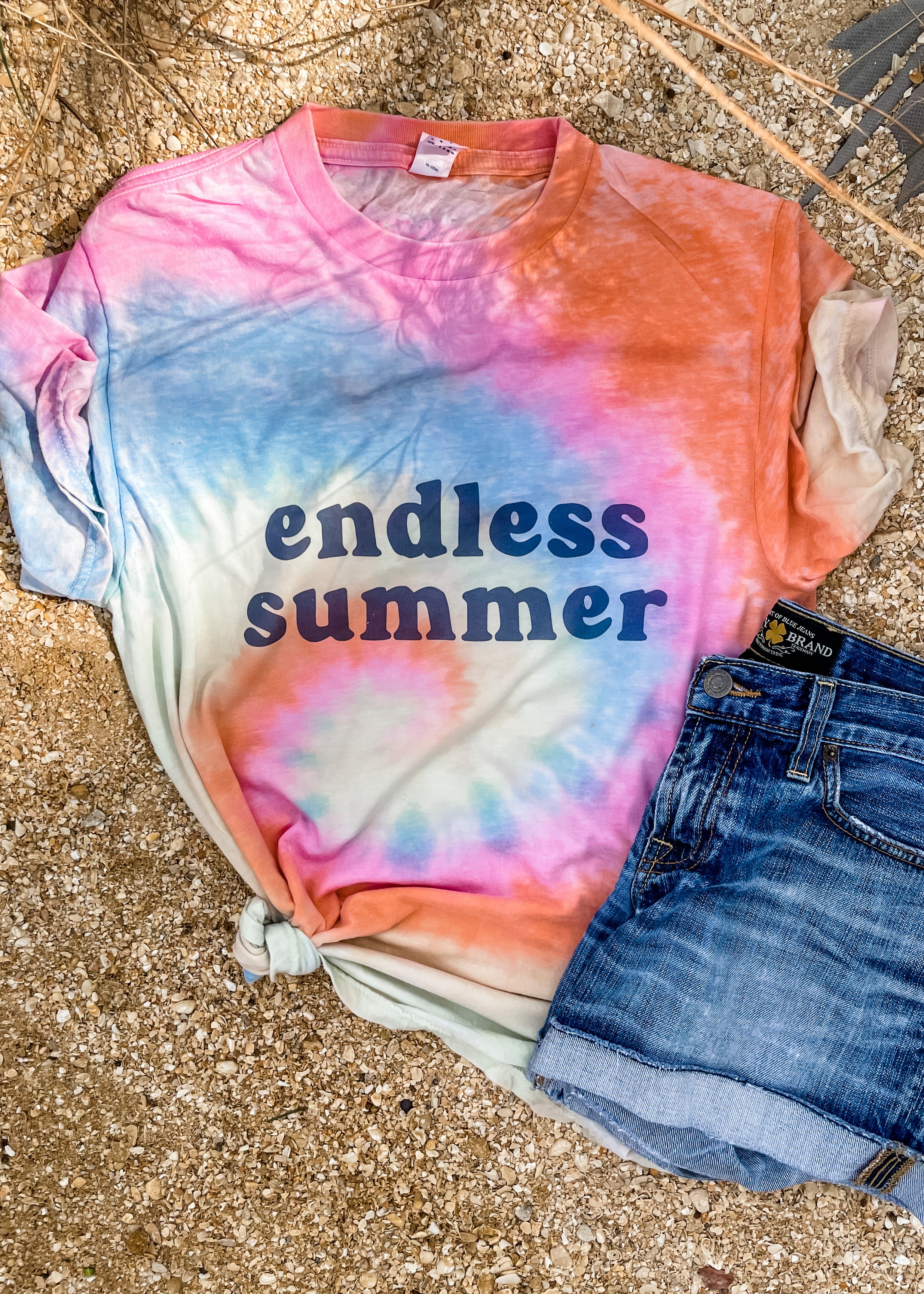 Vintage tie-dyed shirt featuring an endless summer graphic on it.