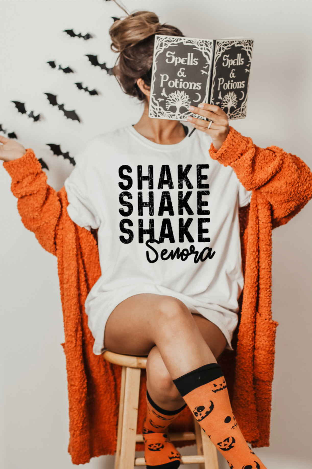 Person wearing a 'Shake Shake Shake Senora' shirt with Halloween-themed accessories.
