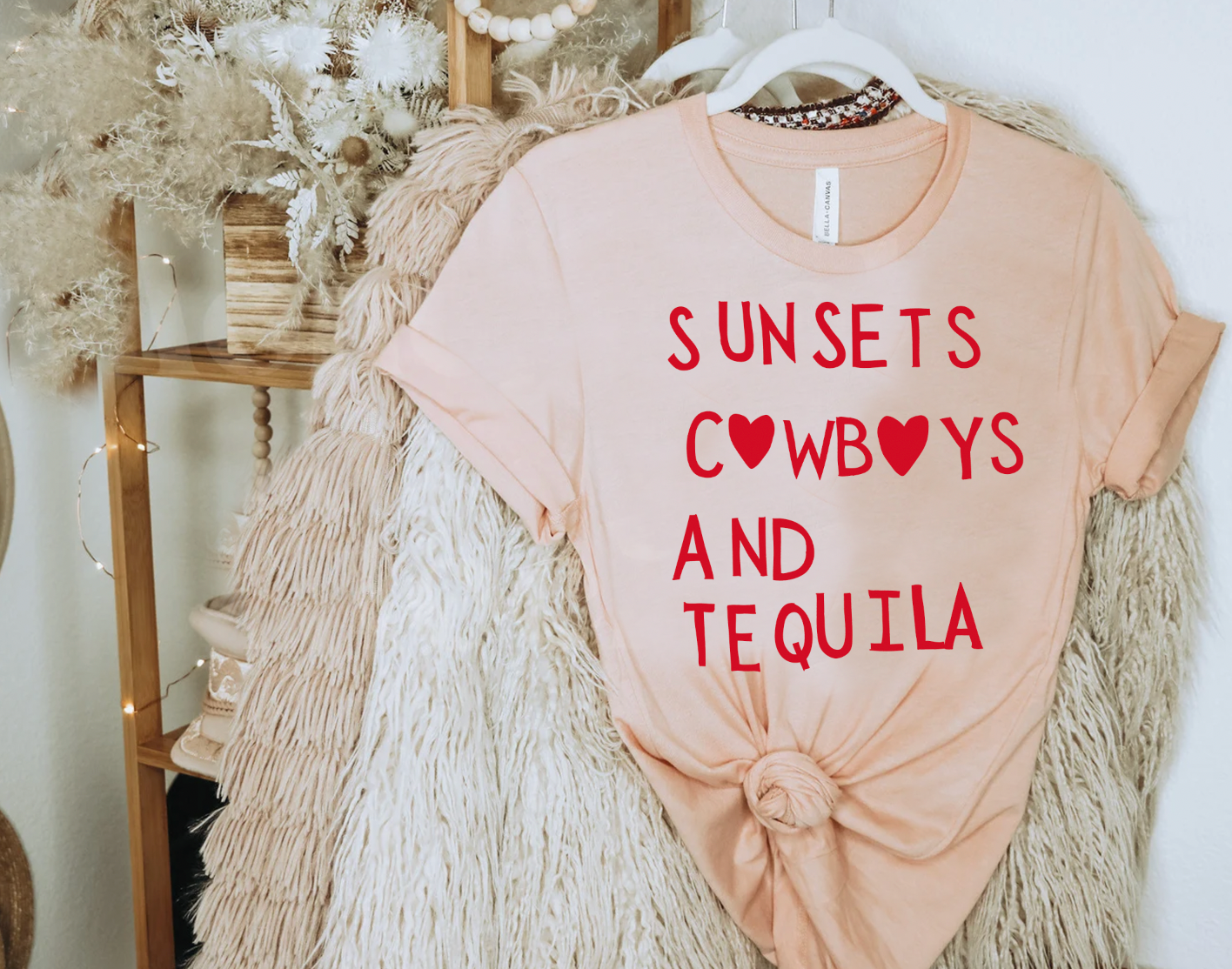 Super soft Bella and Canvas Peach colored vintage country girl tshirt with Sunsets, Cowboys and Tequila on it.