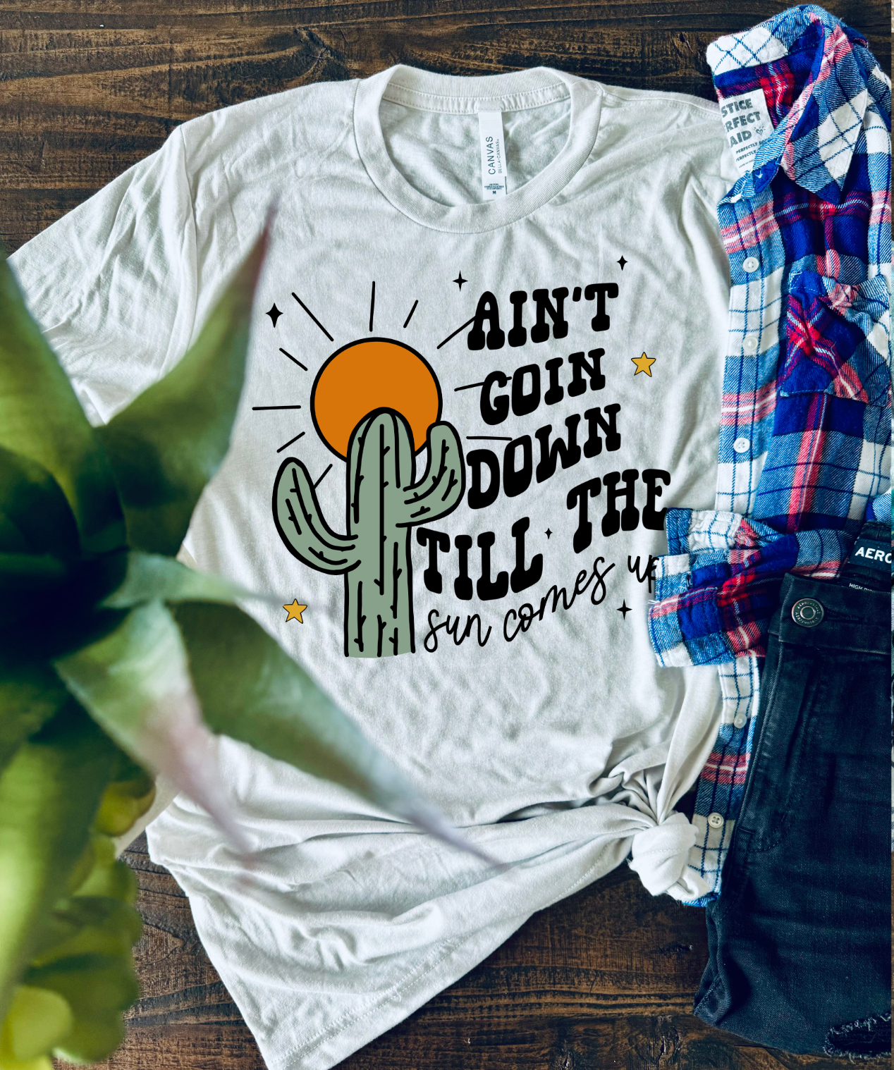 Handmade Bella + Canvas graphic tee with the text "Ain't Going Down Until the Sun Comes Up," perfect for country style and southern charm. White shirt.