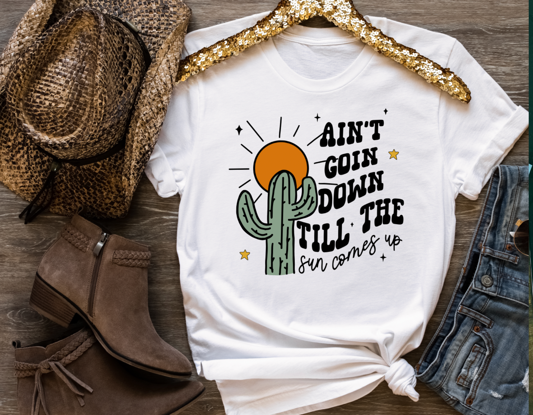Handmade Bella + Canvas graphic tee with the text "Ain't Going Down Until the Sun Comes Up," perfect for country style and southern charm. White Unisex Shirt.