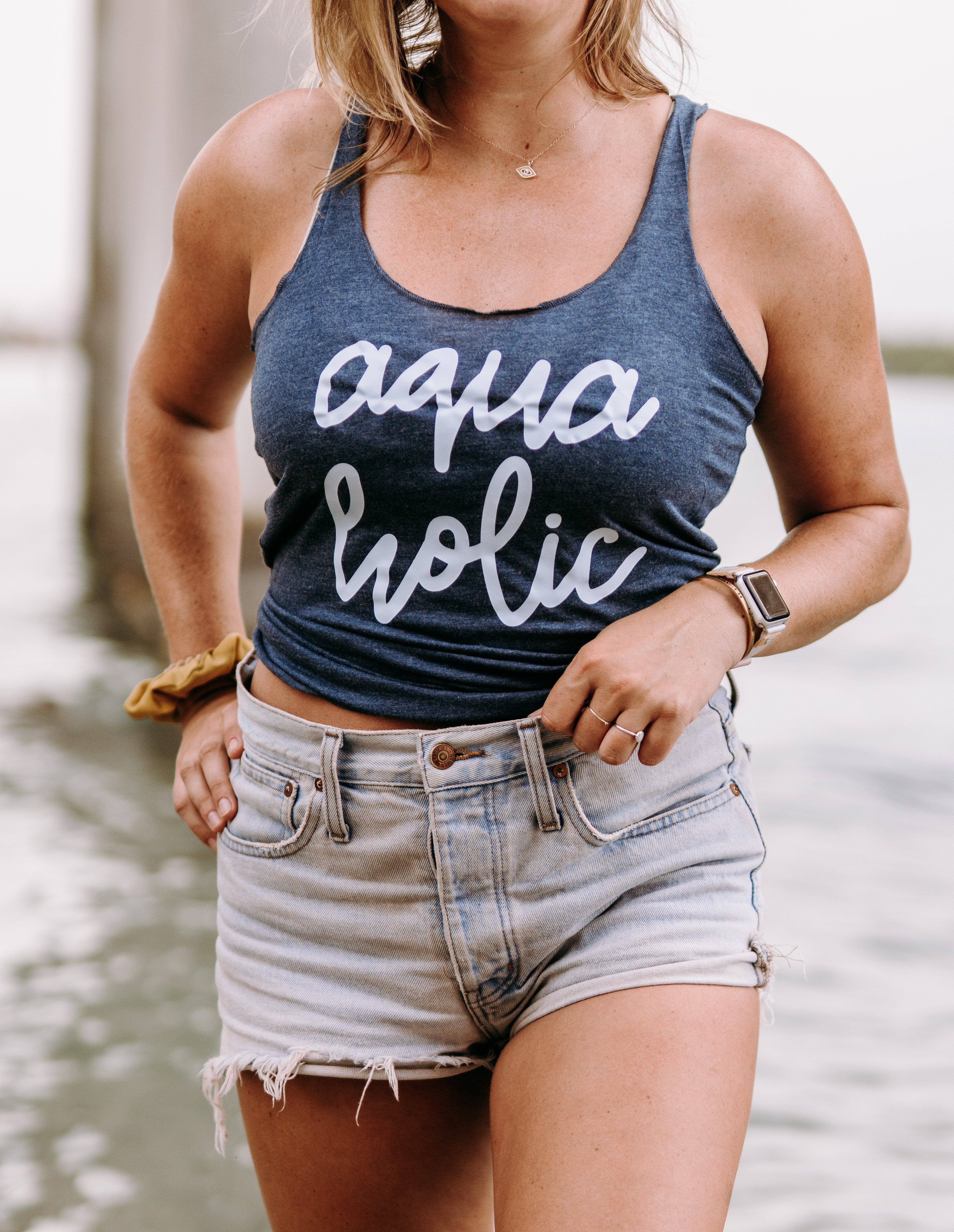 Beach Girl. Summer Girl. Ladies Heather Navy tank with Aquaholic written on it.