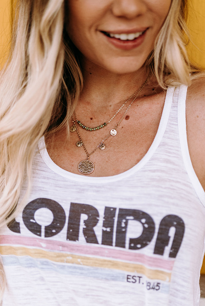 Florida Est. 1845 Racerback Tank: A stylish racerback tank top in honor of Florida's statehood in 1845, perfect for showing Sunshine State pride. The tank features a sporty design and is made from soft, lightweight fabric.